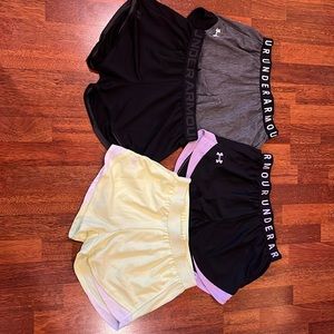 Four pairs of Under Armor junior shorts size Small.